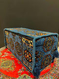 Traditional Turkish Armrest Cushion in blue with intricate patterns and tassels on a colorful floor seating.