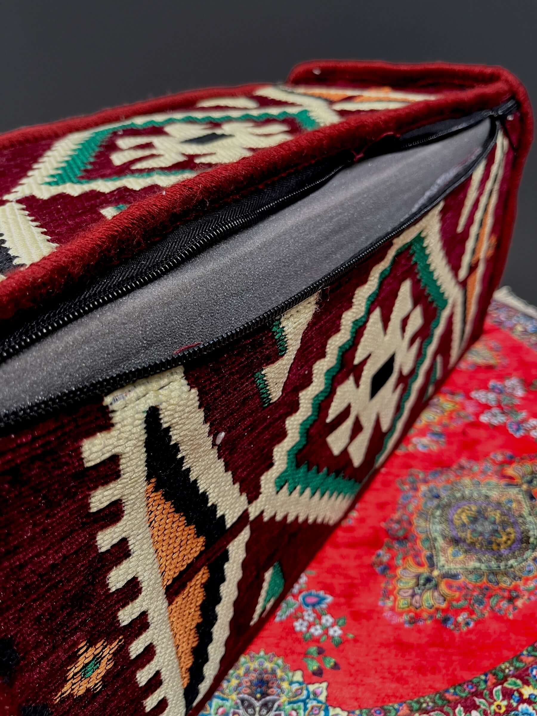 Traditional Turkish Armrest cushion showcasing vibrant colors and intricate patterns on a patterned surface.