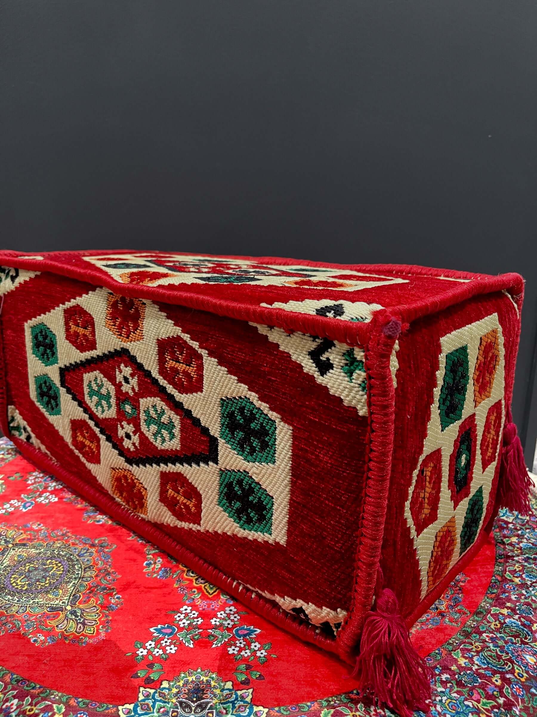 Traditional Turkish Armrest cushion with colorful patterns on a red background, ideal for floor seating support.