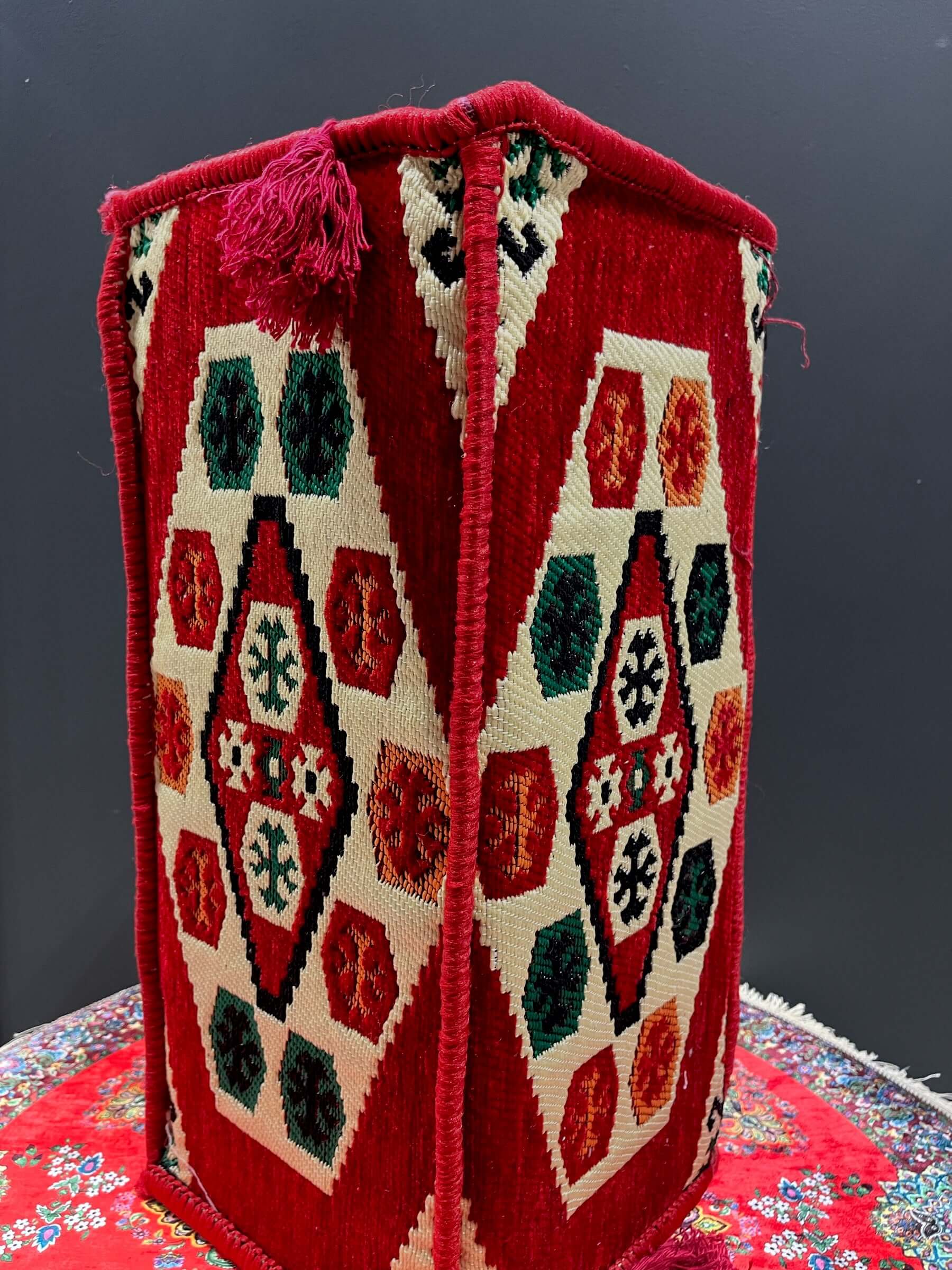 Traditional Turkish Armrest cushion with colorful geometric patterns in red and cream, ideal for seating support.