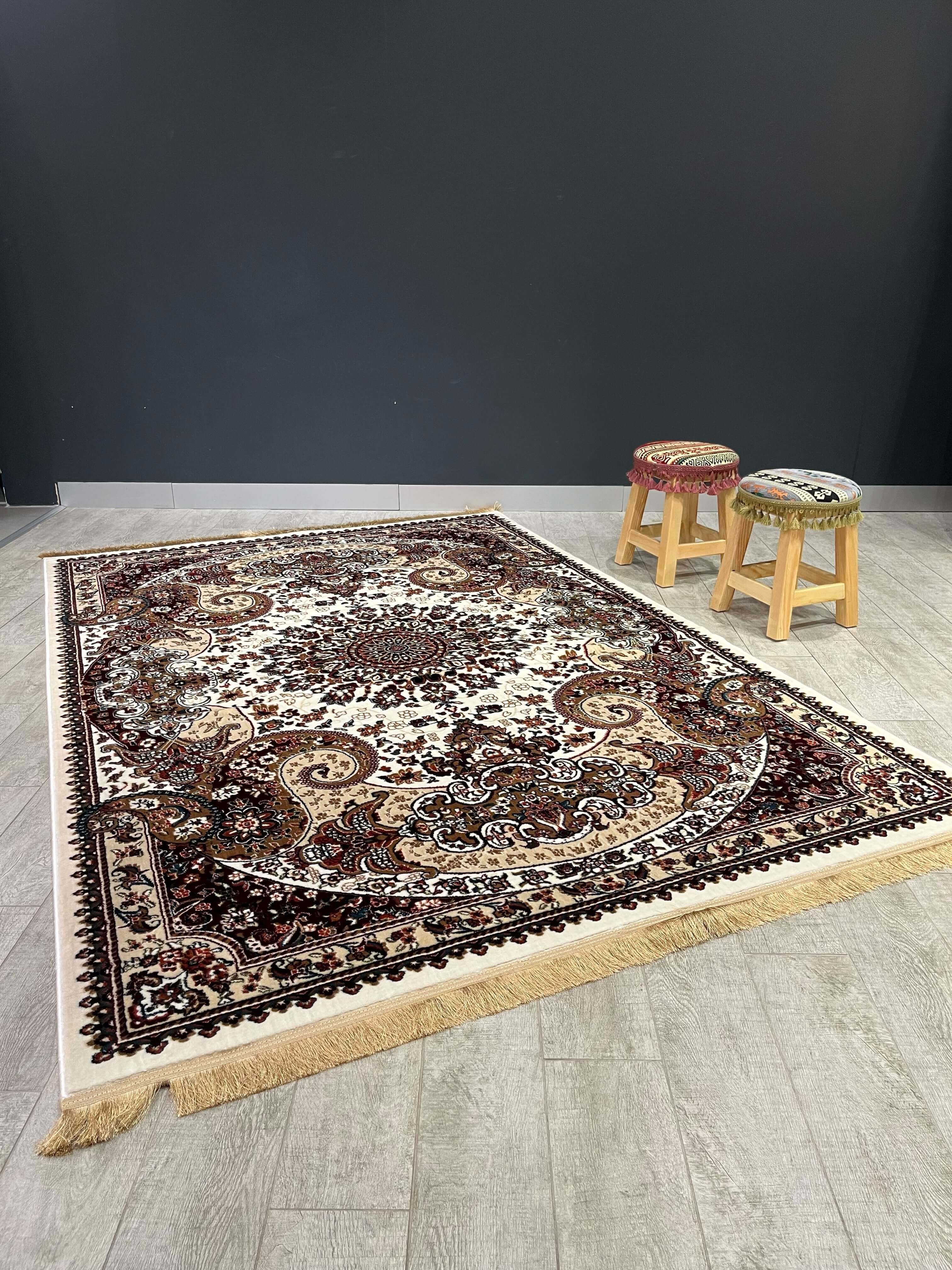 Asaryun Turkish Rug H4030C Cream displayed on a floor with two wooden stools, showcasing its traditional pattern.
