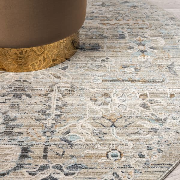 Aubrey 6755 Taupe Round Turkish Rug featuring intricate patterns and a soft cotton base beneath a stylish table.