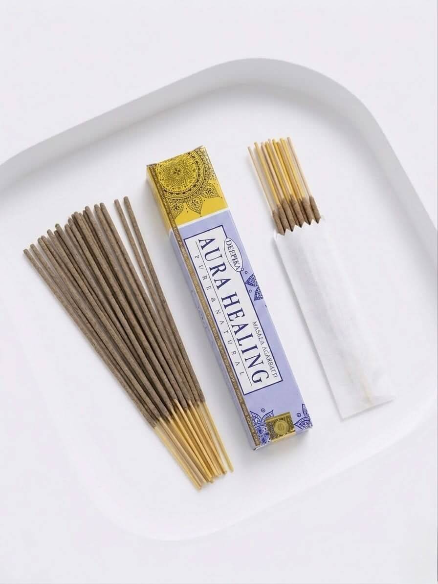 Aura Healing Incense Sticks with packaging and incense sticks arranged on a plate.