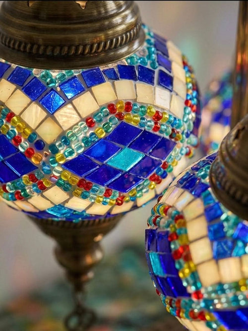 Close-up of authentic Turkish mosaic table lamp featuring intricate sapphire blue and multicolor geometric glass designs.
