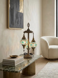 Authentic Turkish mosaic table lamp with blue and green glass, set elegantly on a stylish coffee table.