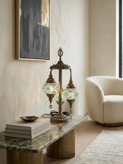 Authentic Turkish mosaic table lamp with blue and green glass, set elegantly on a stylish coffee table.