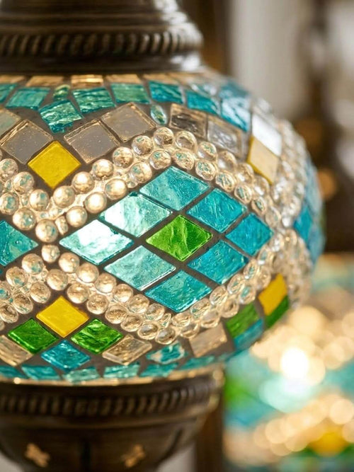 Turkish mosaic table lamp featuring vibrant turquoise and green stained glass with intricate geometric design.