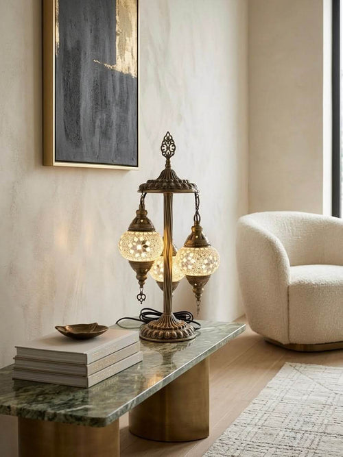 Elegant Turkish mosaic table lamp with three globes on a modern green tabletop, creating a warm ambiance.
