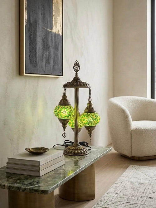 Authentic handcrafted Turkish mosaic table lamp with green glass globes on a stylish table.