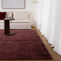 Reverie Chocolate Cherry Viscose Rug styled with furniture