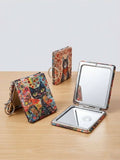 Compact Folding Mirror Keychain with artistic cat design, perfect for touch-ups on the go.