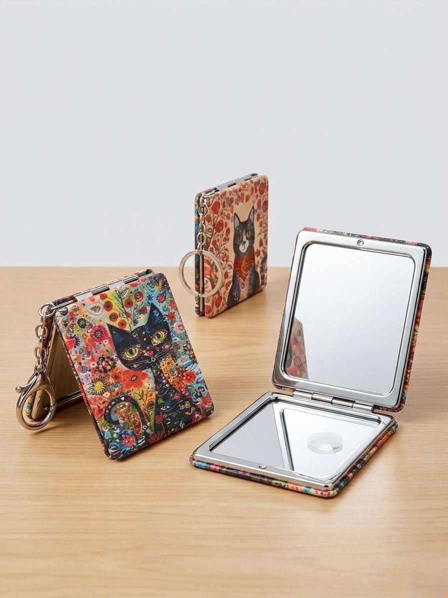Compact Folding Mirror Keychain with artistic cat design, perfect for touch-ups on the go.