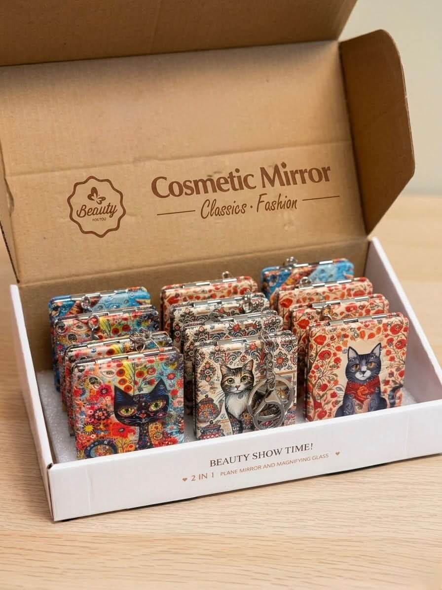 Compact Folding Mirror Keychain displayed in a box featuring artistic cat designs and patterns.