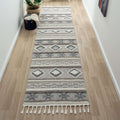 Cottage 546 slate runner in a cozy hallway featuring geometric patterns and braided fringes.