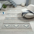 Cottage 546 slate area rug displayed in a cozy room with modern decor and geometric motifs.