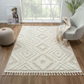 Cottage 548 sand rugs displayed in a cozy living area with geometric motifs and braided fringes.