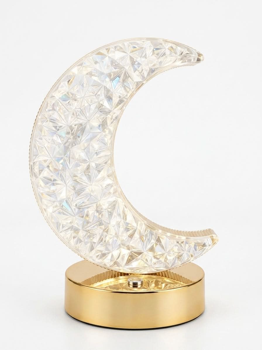 Dimmable crystal crescent moon lamp on a polished gold base, perfect for stylish bedroom decor.