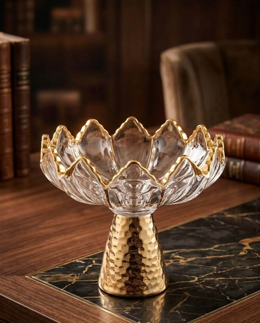 Glass Crystal Fruit Bowl with Gold Stand elegantly displayed on a marble table with books in the background.