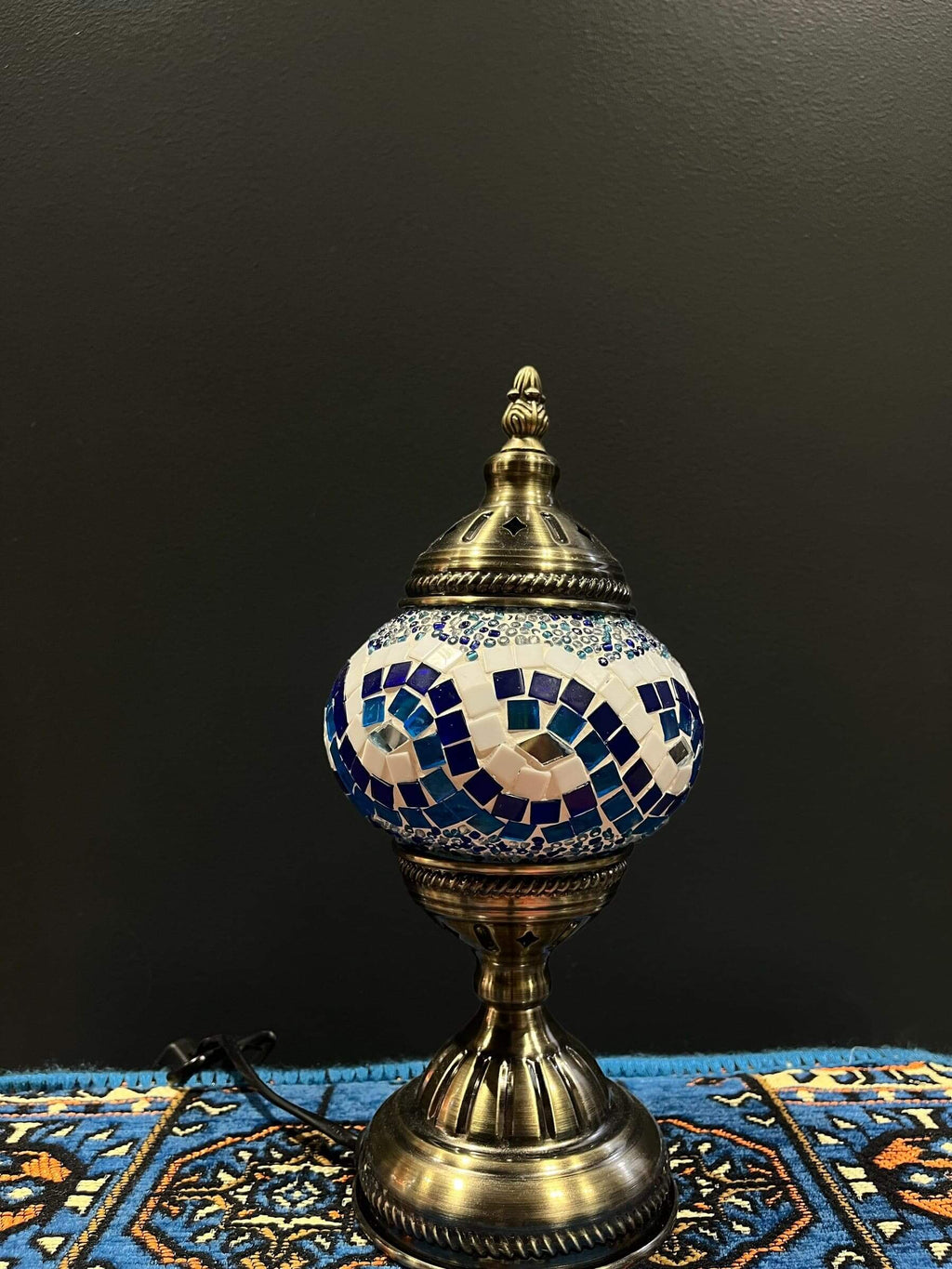 Mosaic Table Lamp in blue and white glass with intricate design on a decorative table.