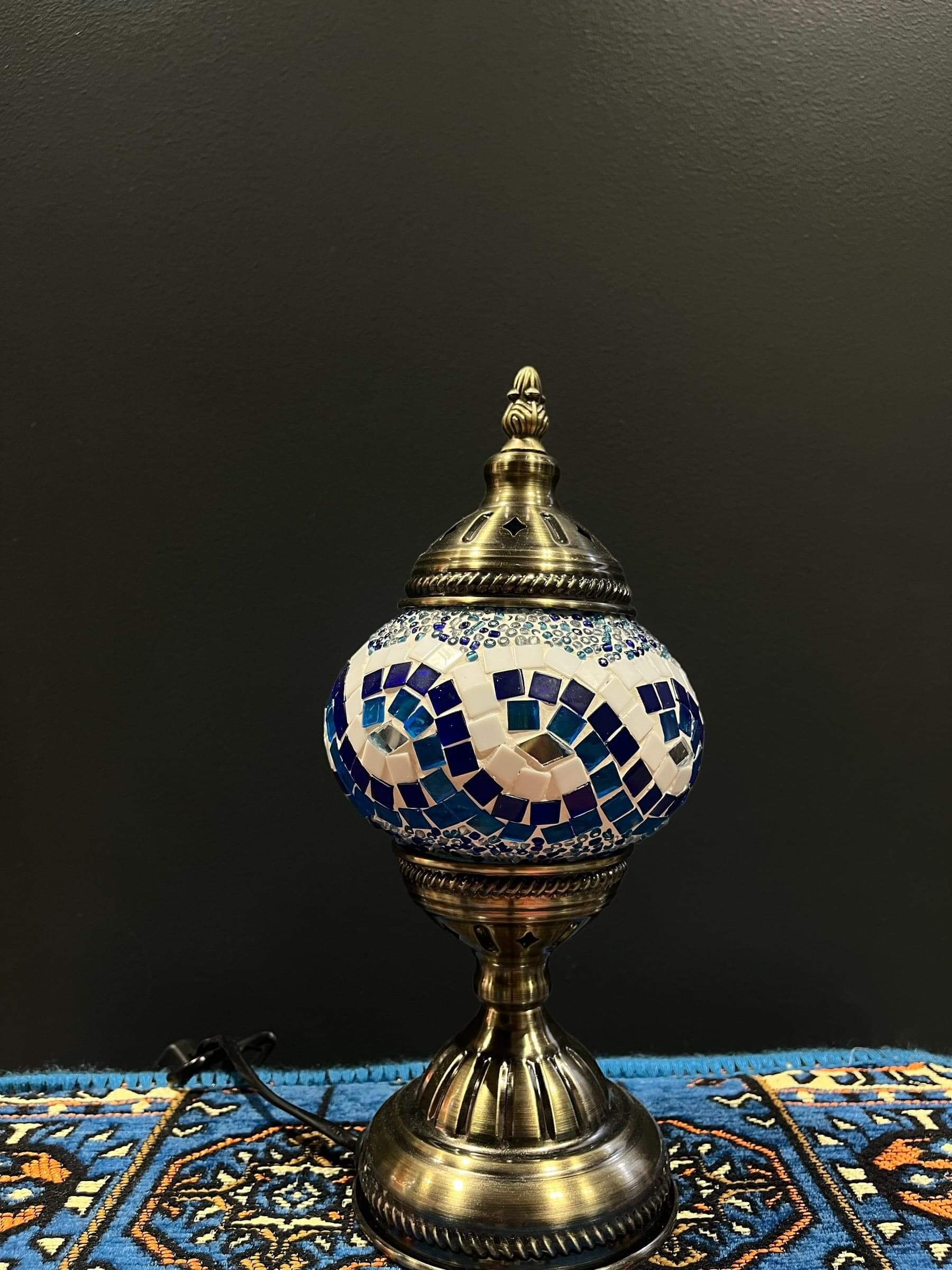 Mosaic Table Lamp in blue and white glass with intricate design on a decorative table.