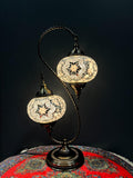 Swan-Shaped Mosaic Lamp with intricate glass designs, illuminating a decorative table with a warm glow.