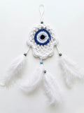 Evil Eye Dream Catcher handcrafted wall art with white crochet and feathers, measuring 10x15cm.
