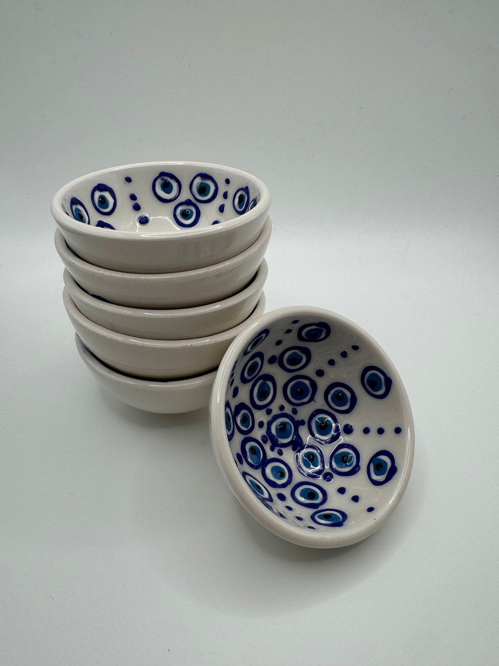 Evil Eye Turkish Ceramic Mini Bowls stacked with vibrant blue Nazar design on white glaze.