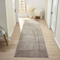 beige minimalist runner rug placed in a bright hallway with elegant decor and natural light.