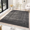 Minimalist grey area rug positioned elegantly in a modern interior with natural light.