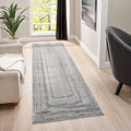 Grey minimalist runner rug placed in a stylish living room setting with natural light.