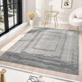Minimalist grey area rug displayed in a modern living room with elegant decor and natural light.