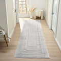 Minimalist grey area rug placed in a serene hallway with natural light and neutral decor.