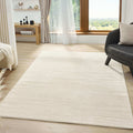 Elegant minimalist area rug in a bright living room with large window and modern furnishings.