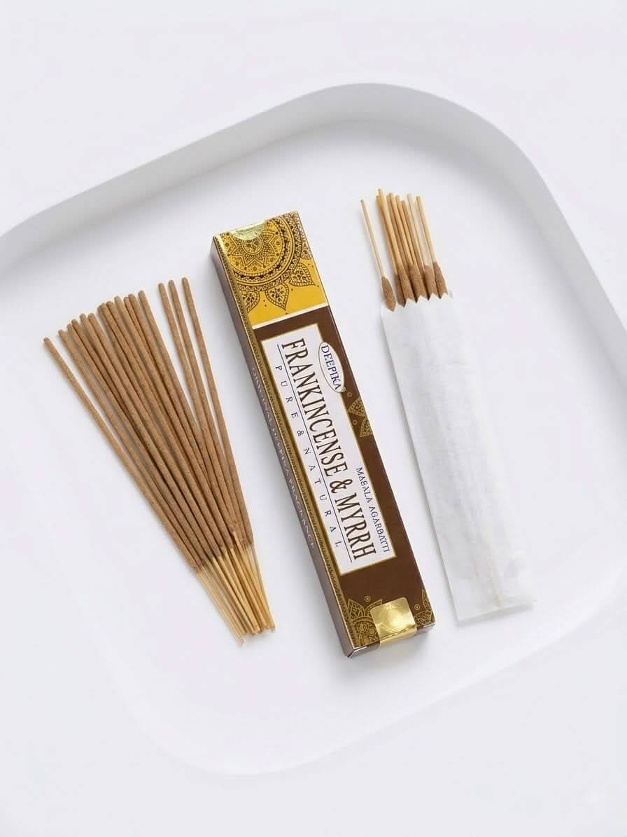 Frankincense & Myrrh Incense Sticks in a stylish box with sticks displayed on a white plate.