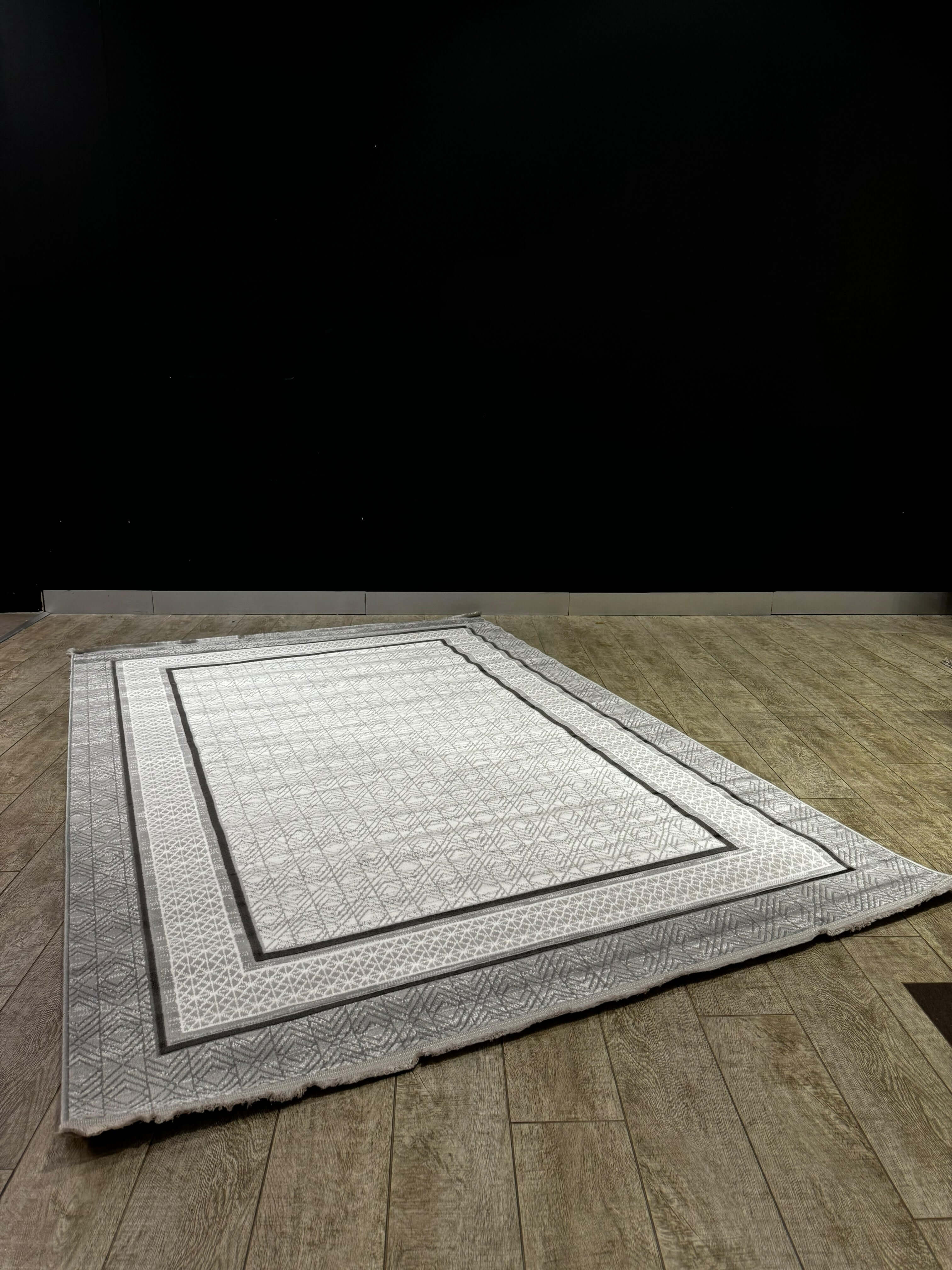 Geometric Border Premium Turkish Rug – Modern Elegance Collection displayed on wooden floor