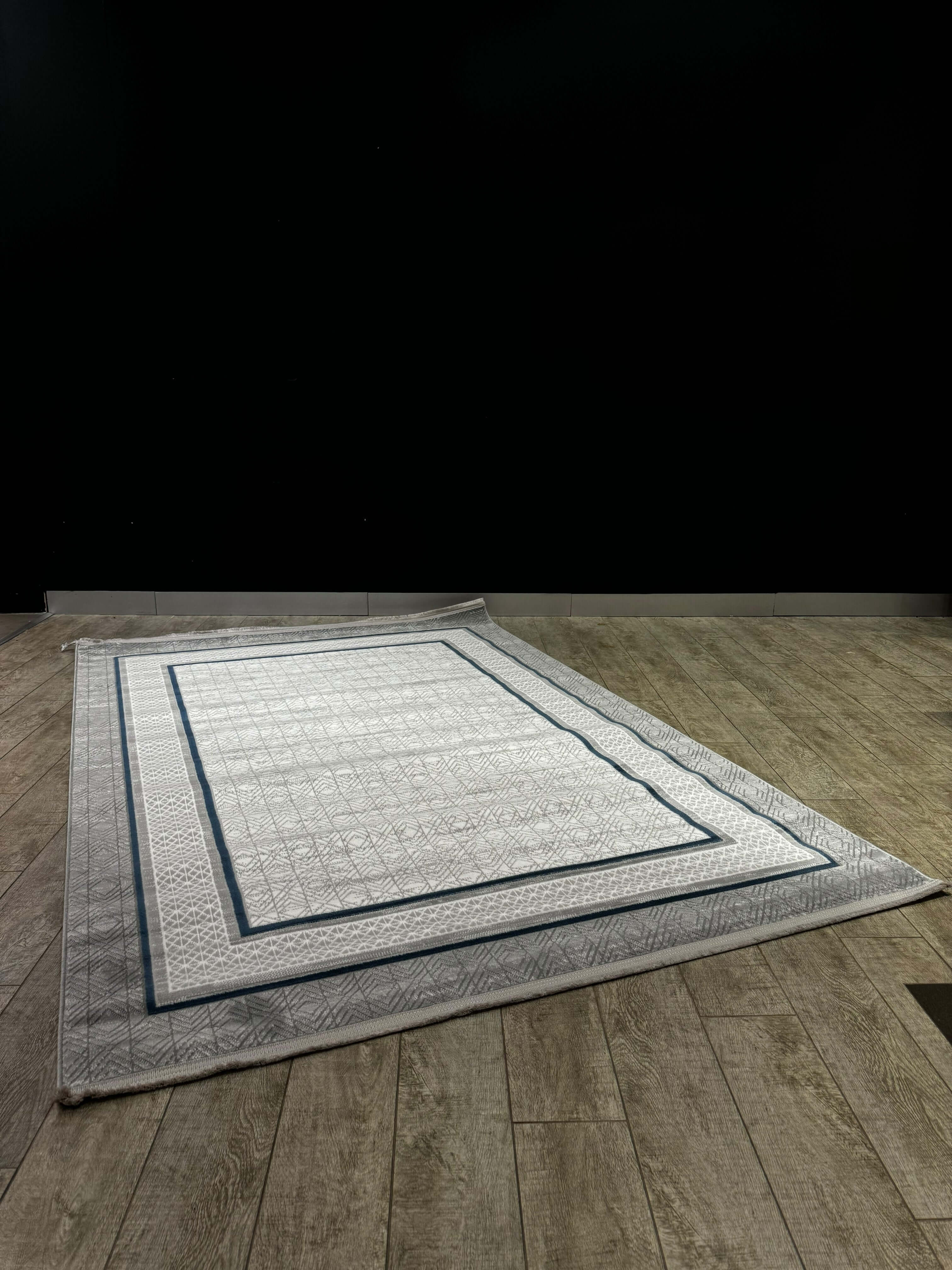 Geometric Border Premium Turkish Rug shown on wooden floor, part of the Modern Elegance Collection, elegant geometric design.