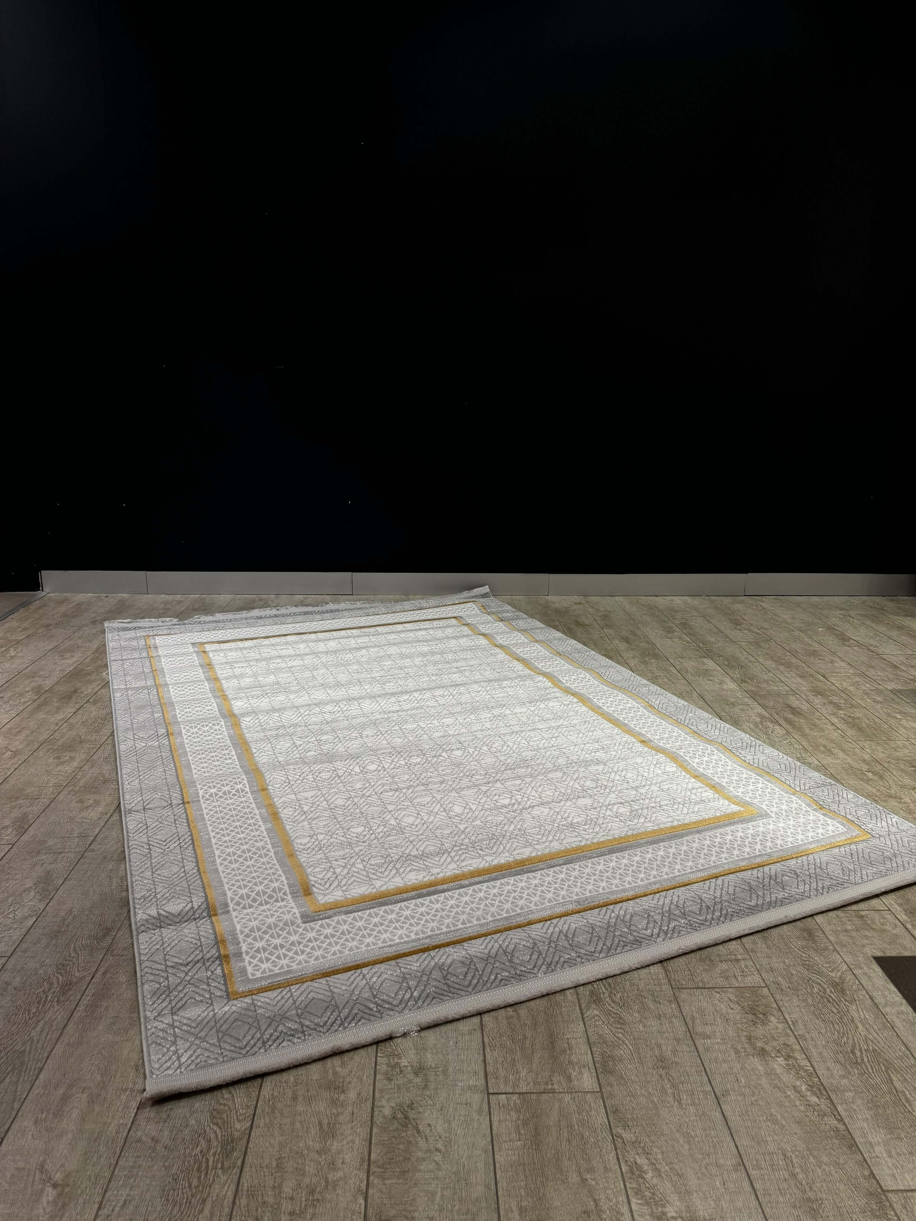 Geometric Border Premium Turkish Rug – Modern Elegance Collection displayed on wooden floor.