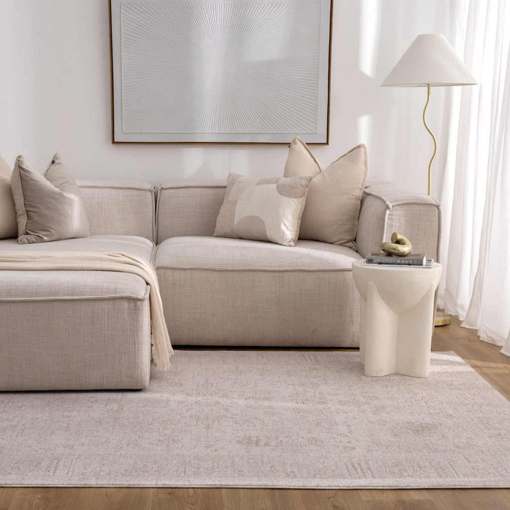 Heritage H106 Beige Distressed Border Rug styled with furniture