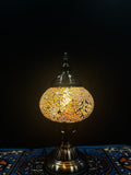 Mosaic Table Lamp Gold Crackle illuminating a vibrant glass mosaic design on a decorative lamp.