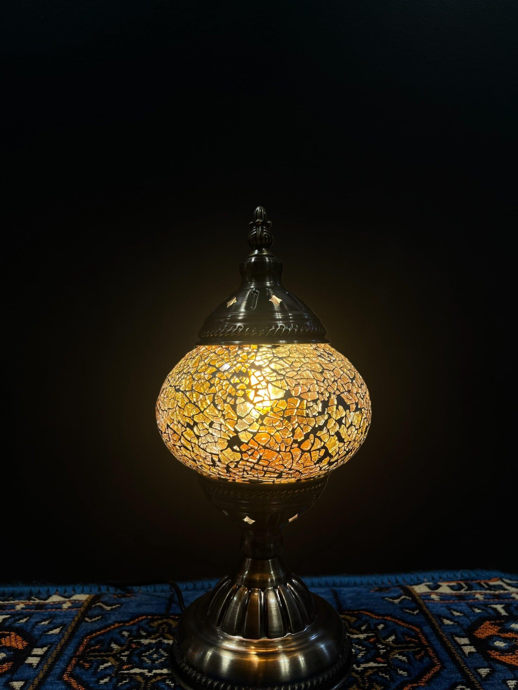 Mosaic Table Lamp Gold Crackle illuminating a vibrant glass mosaic design on a decorative lamp.