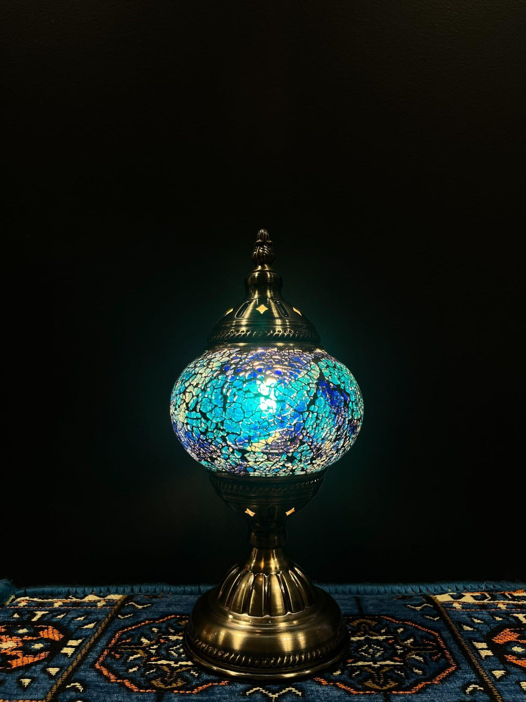 Mosaic Table Lamp featuring blue crackle glass design illuminating a cozy space.