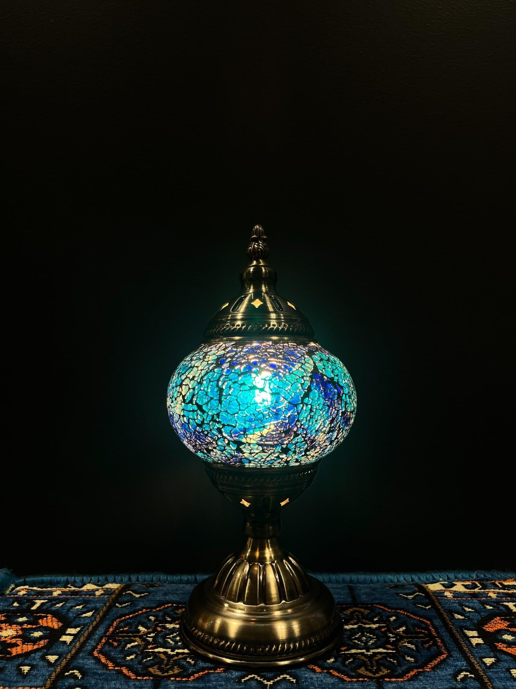 Mosaic Table Lamp featuring blue crackle glass design illuminating a cozy space.
