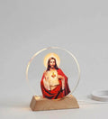 LED Jesus Acrylic Night Lamp illuminating a serene image of Jesus on a wooden base, creating a peaceful atmosphere.
