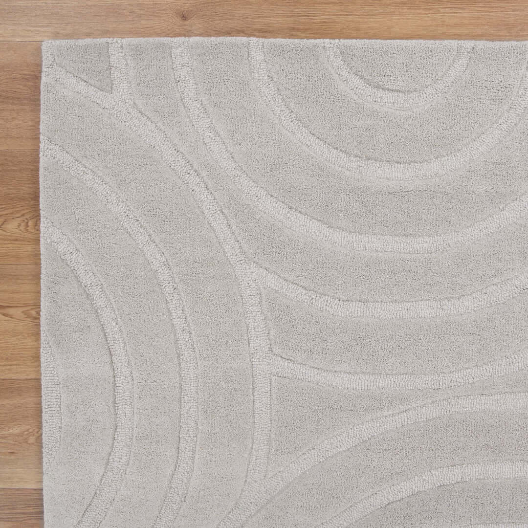 Les Nomades Ellipse Light Grey wool rug - styled view