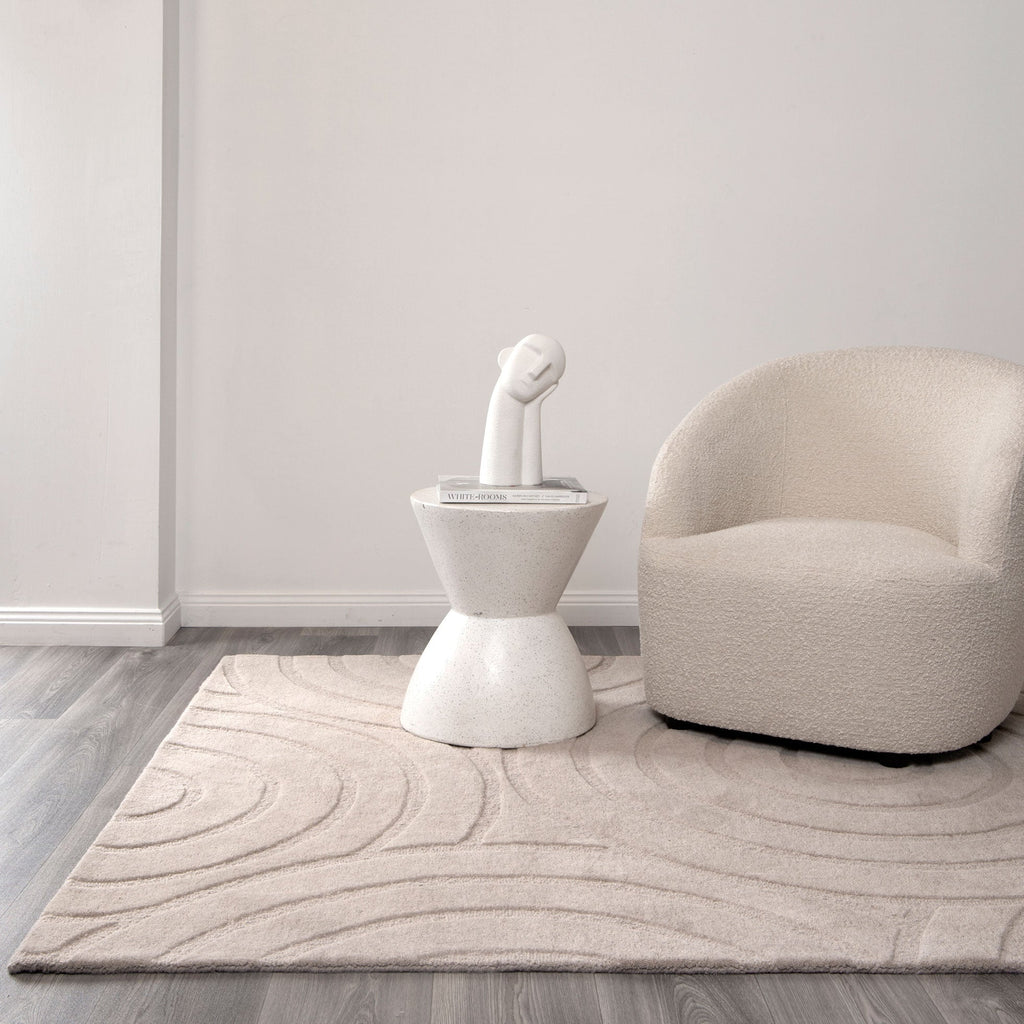Les Nomades Ellipse Beige Wool Rug styled with furniture