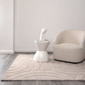 Les Nomades Ellipse Beige Wool Rug styled with furniture