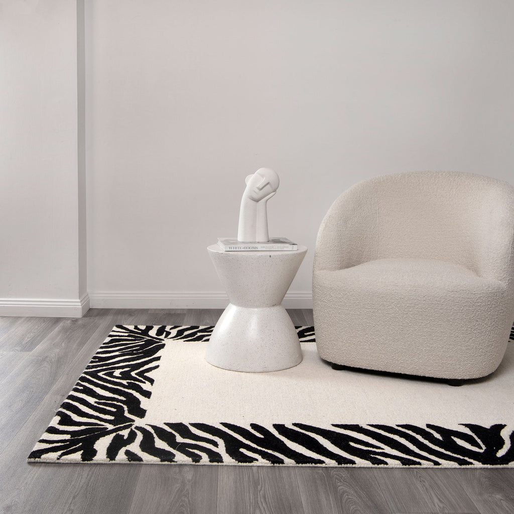 Les Nomades Zanzibar Black & White Wool Rug styled with furniture