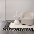 Les Nomades Zanzibar Black & White Wool Rug styled with furniture