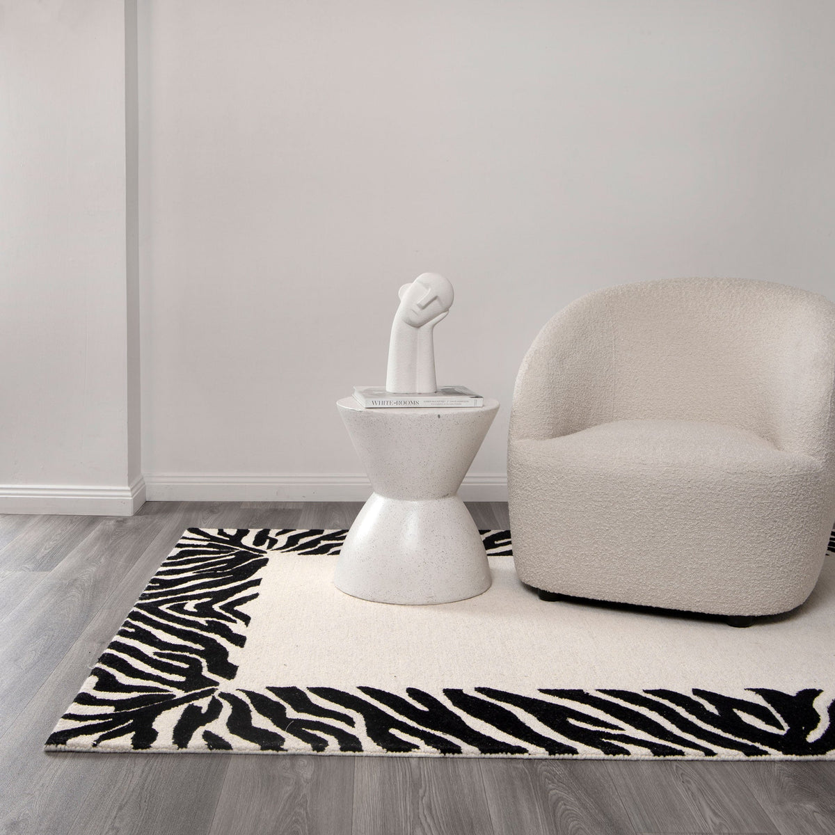 Les Nomades Zanzibar Black & White Wool Rug styled with furniture