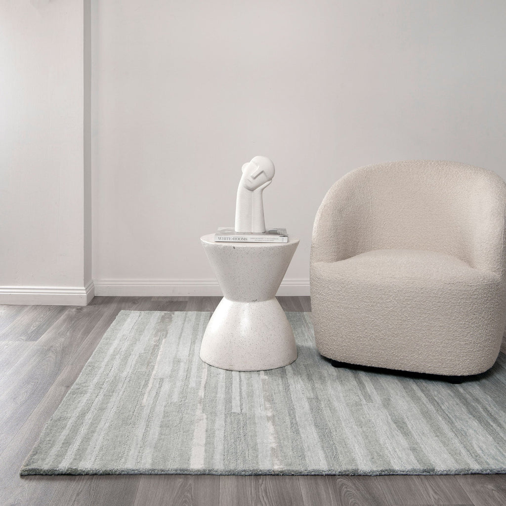 Les Nomades Linear Light Ash Wool Rug styled with furniture